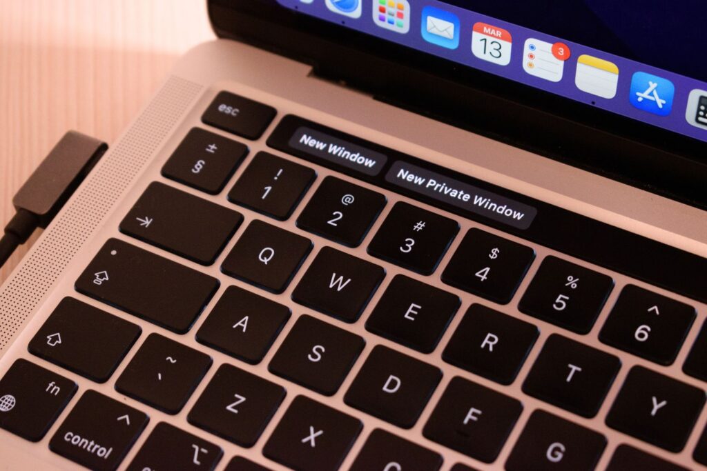 Close-up of a laptop keyboard with browser window options displayed