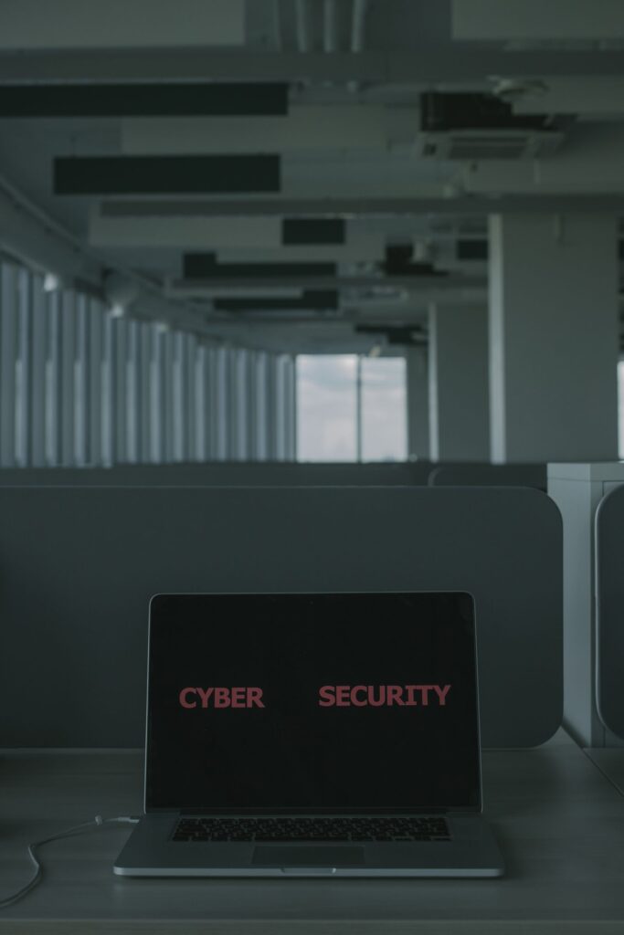 Laptop displaying a cyber security warning screen in a dim office