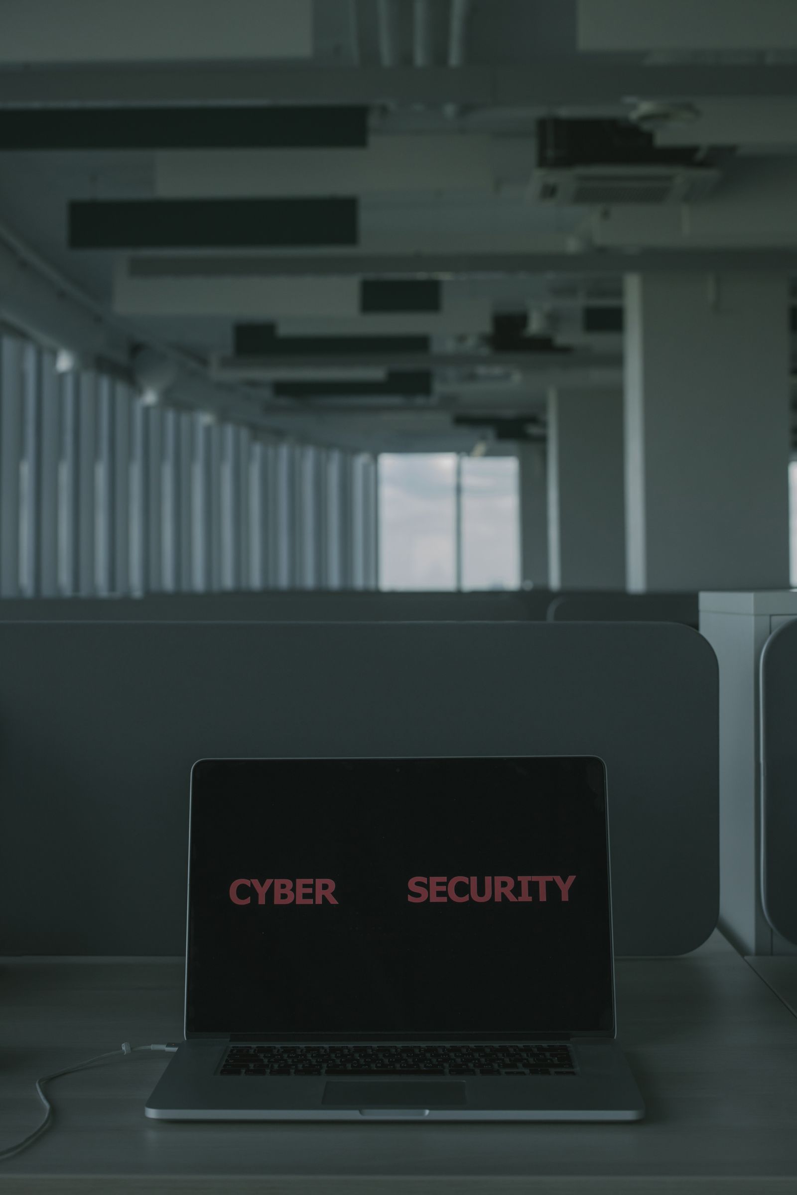 Laptop displaying a cyber security warning screen in a dim office