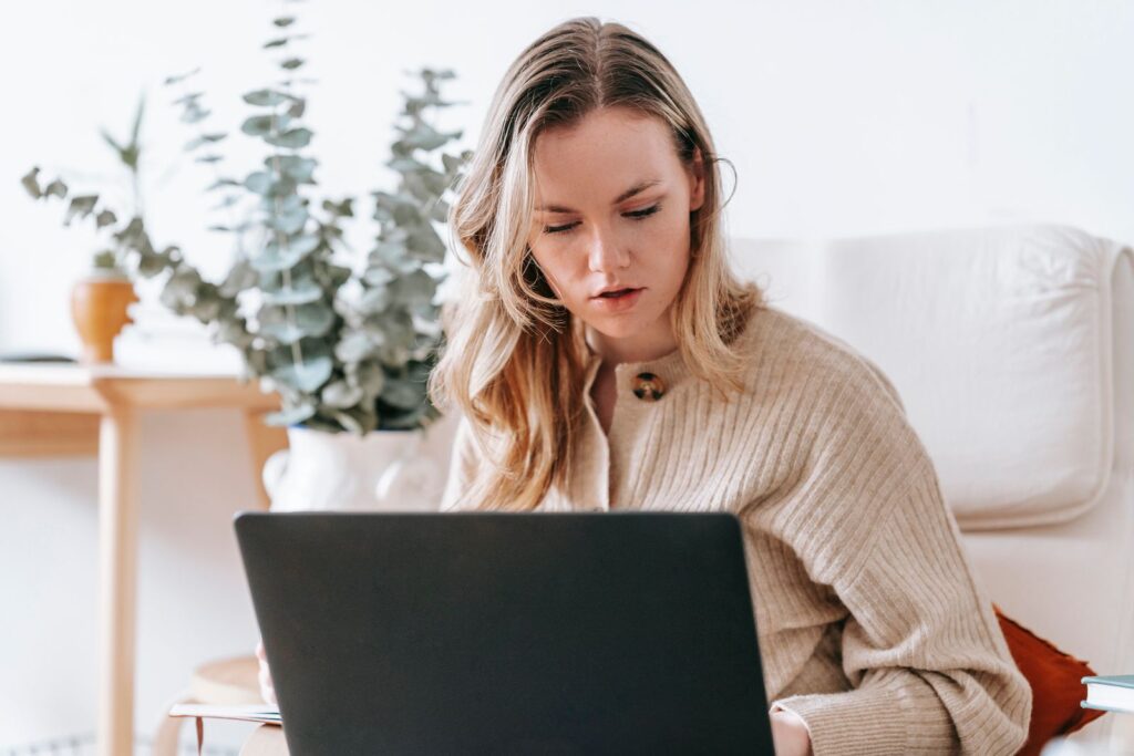 Freelancer working on a laptop in a bright home office