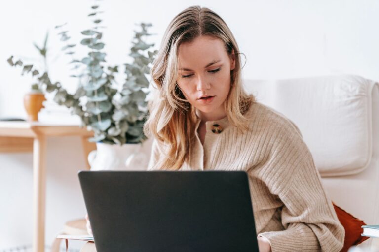 Freelancer working on a laptop in a bright home office