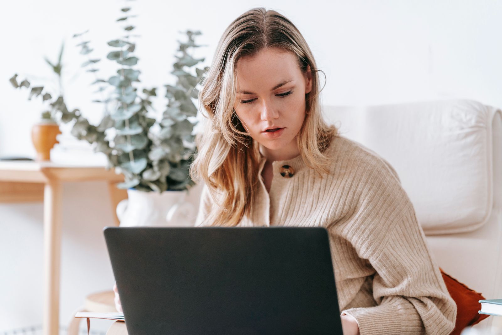 Freelancer working on a laptop in a bright home office