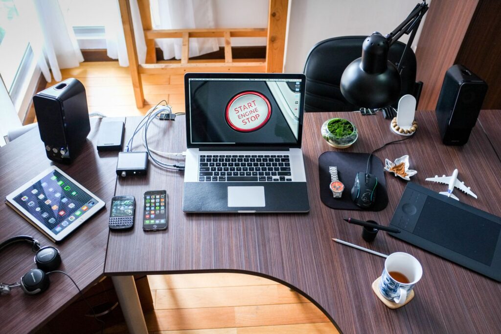 Desk with a laptop, monitor and accessories arranged on a wooden surface