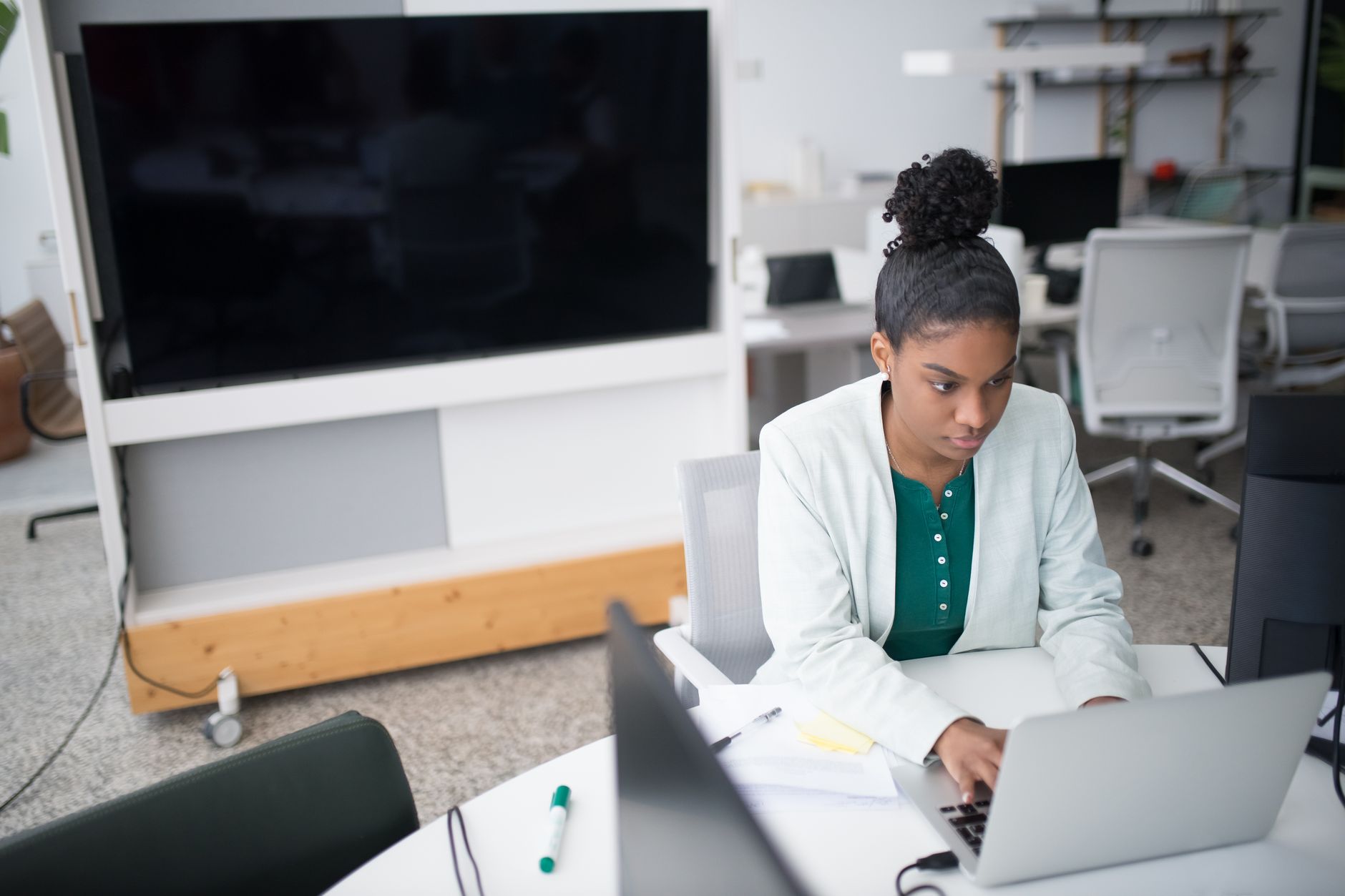 Woman working at a laptop in a bright modern office